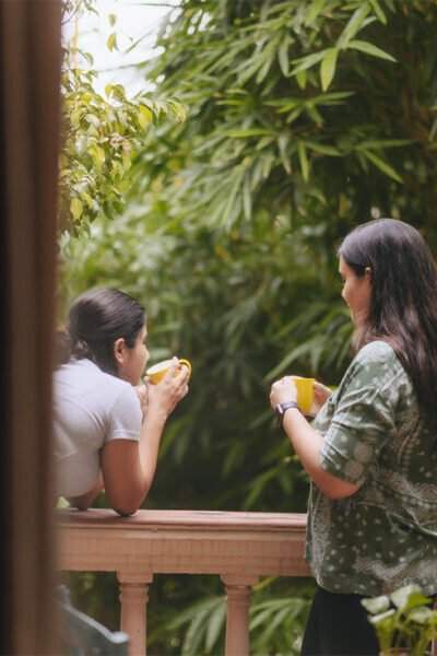 Two people engaged in conversation at Karma Chalets, capturing a candid moment