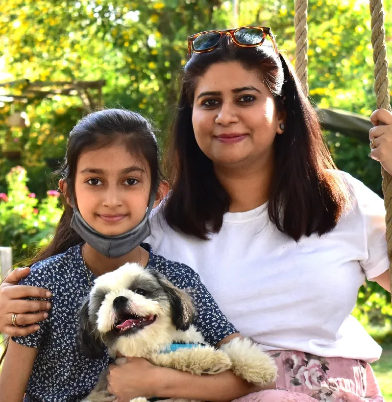 a family enjoying vacations with their pet at pet friendly & best resort near gurugram.